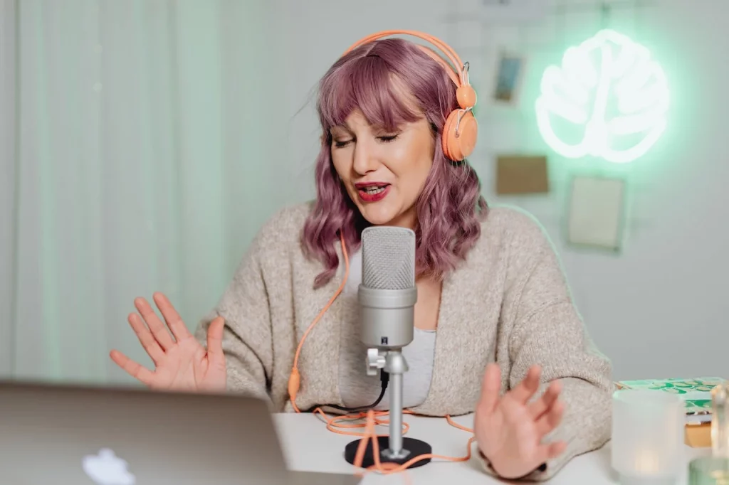 Woman recording a podcast witha. guest remotely
