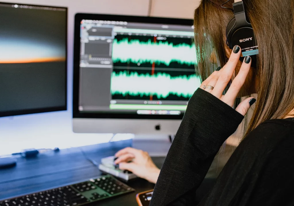 Female podcast producer editing audio for a podcast